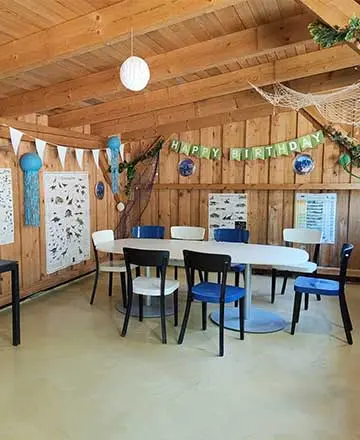 Birthday hut with decorated tables and seating for children’s parties